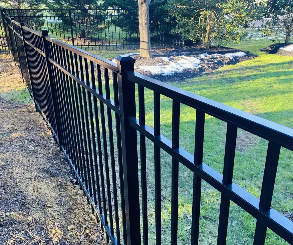 A black aluminum fence in a yard