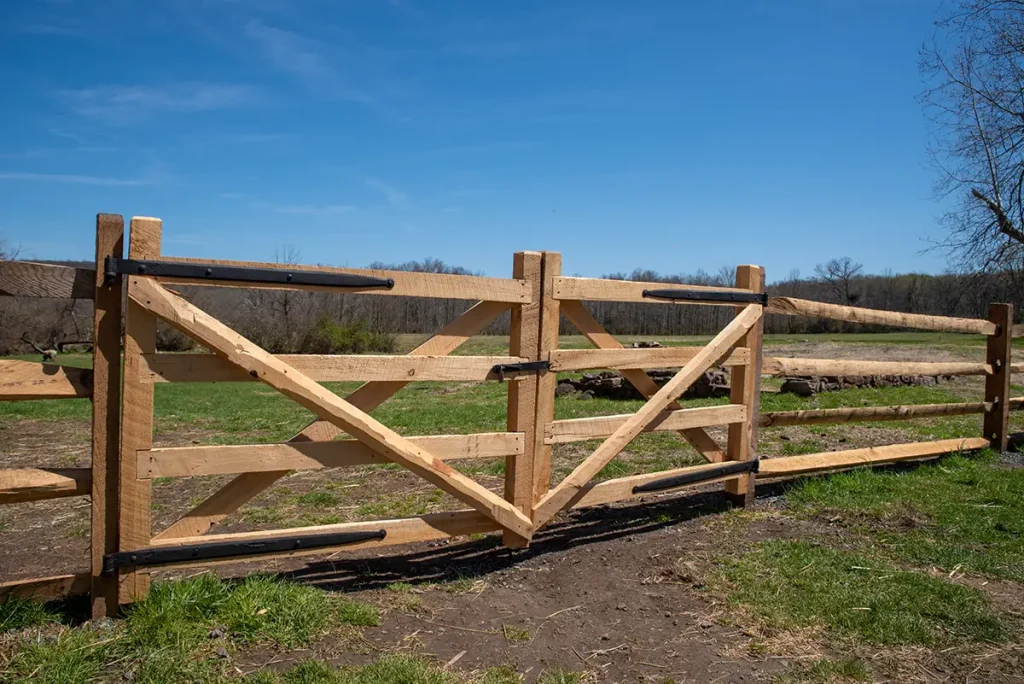 Gated wooden split rail fence.